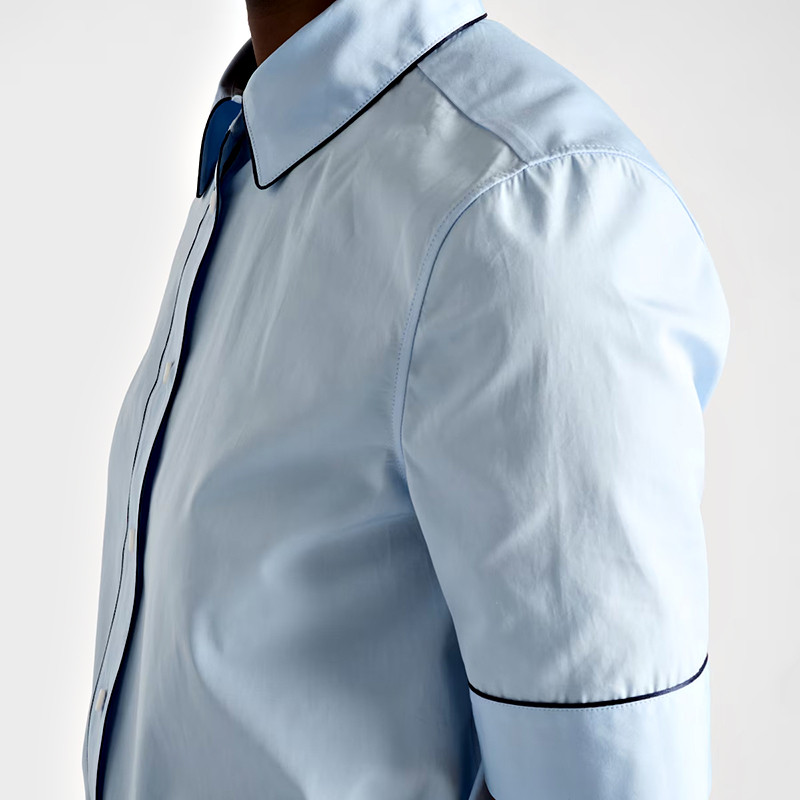 Close detail of contrast piping on the short sleeve shirt collar and sleeve