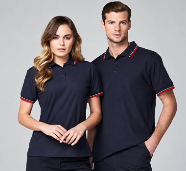 Woman and man wearing matching navy polo shirts with red trim.