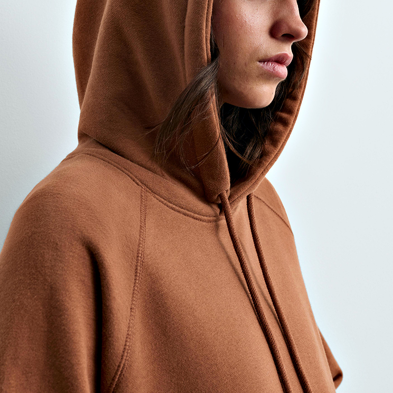 Close-up of the camel hoodie hood and raglan shoulder seam with drawcord