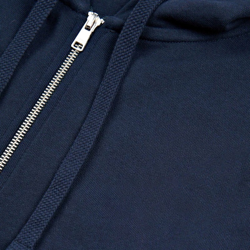 Close-up of the metal zipper and tipped drawcords on a navy zip-up hoodie