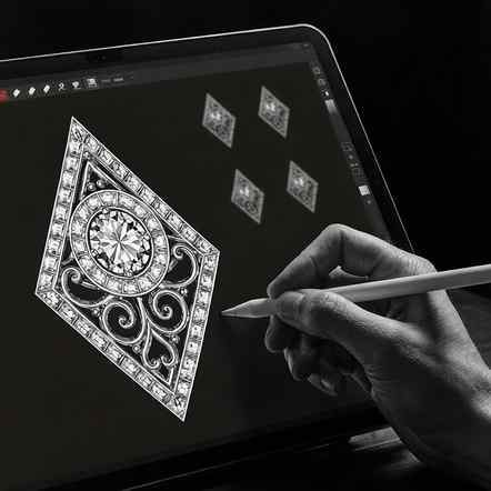 Designer hand-sketching a detailed pendant layout with accent stones on a tablet