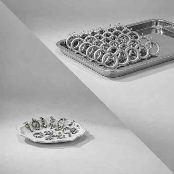 Multiple 925 sterling silver rings on production trays ready for a mixed futures order