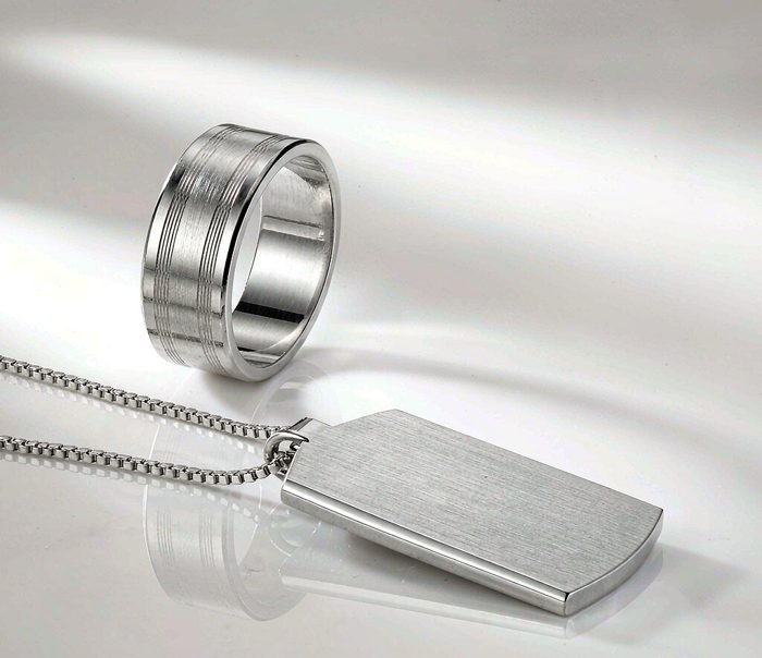 925 sterling silver ring and pendant on a clean white surface, minimalist editorial photography