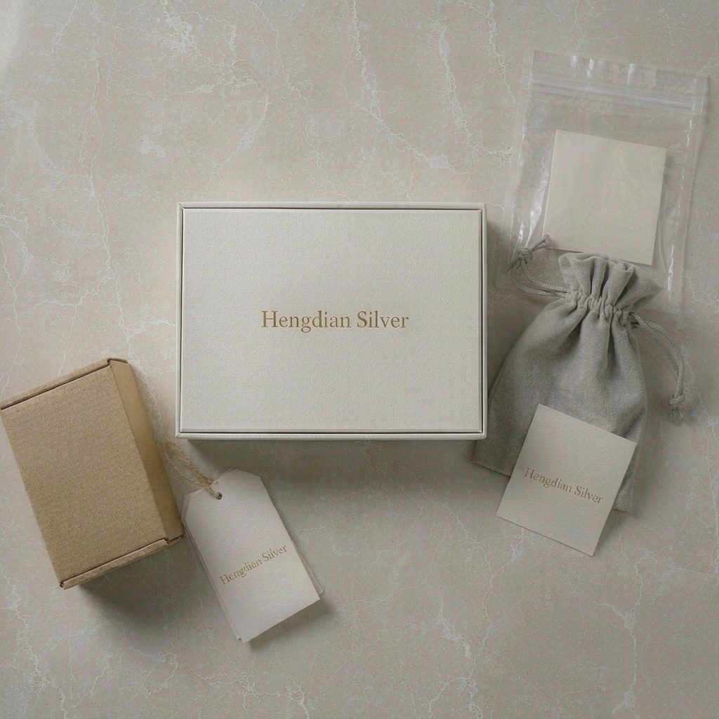 Custom jewellery packaging: gift box, velvet drawstring pouch, kraft box, brand cards and hang tags