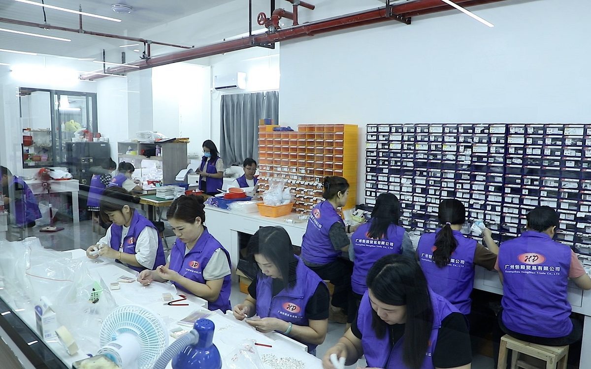 Inside Hengdian Silver's own factory: craftsmen assembling fine silver jewelry at the workshop