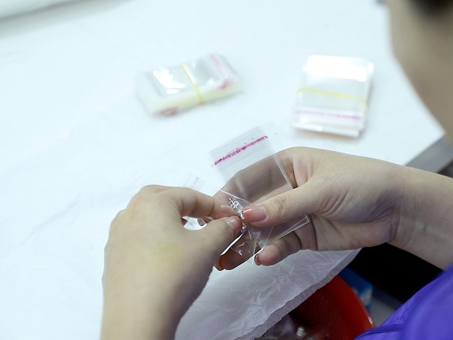 Jewelry being packed in a standard protective OPP bag before shipment