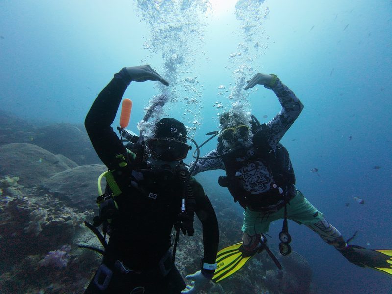 Our founders diving together over a coral reef