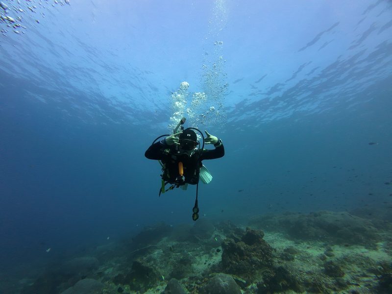 A diver hovering in clear open blue water