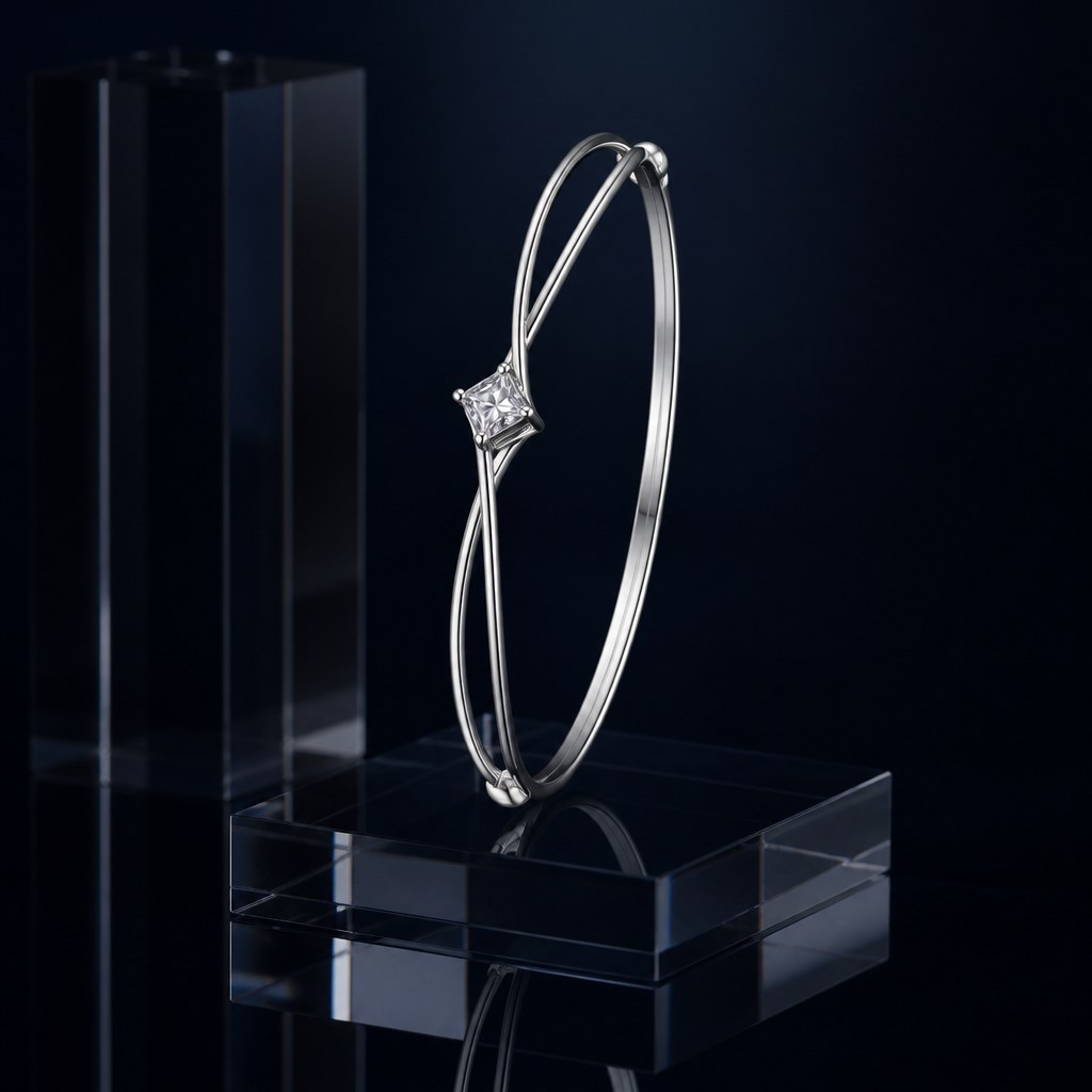 Twisted Double Strand Bangle standing on edge against a dark acrylic column, both crossings in profile