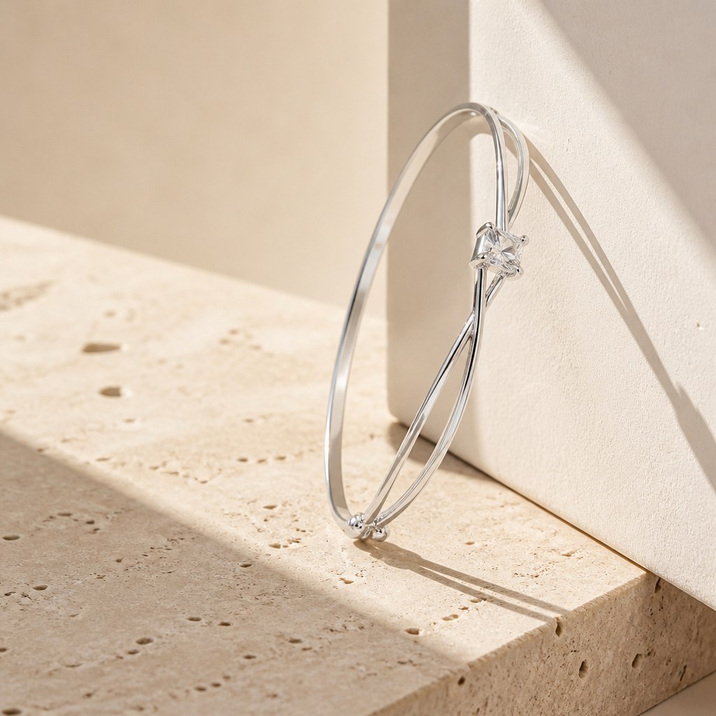 Twisted Double Strand Bangle from above on travertine, both crossings and the stone seat visible