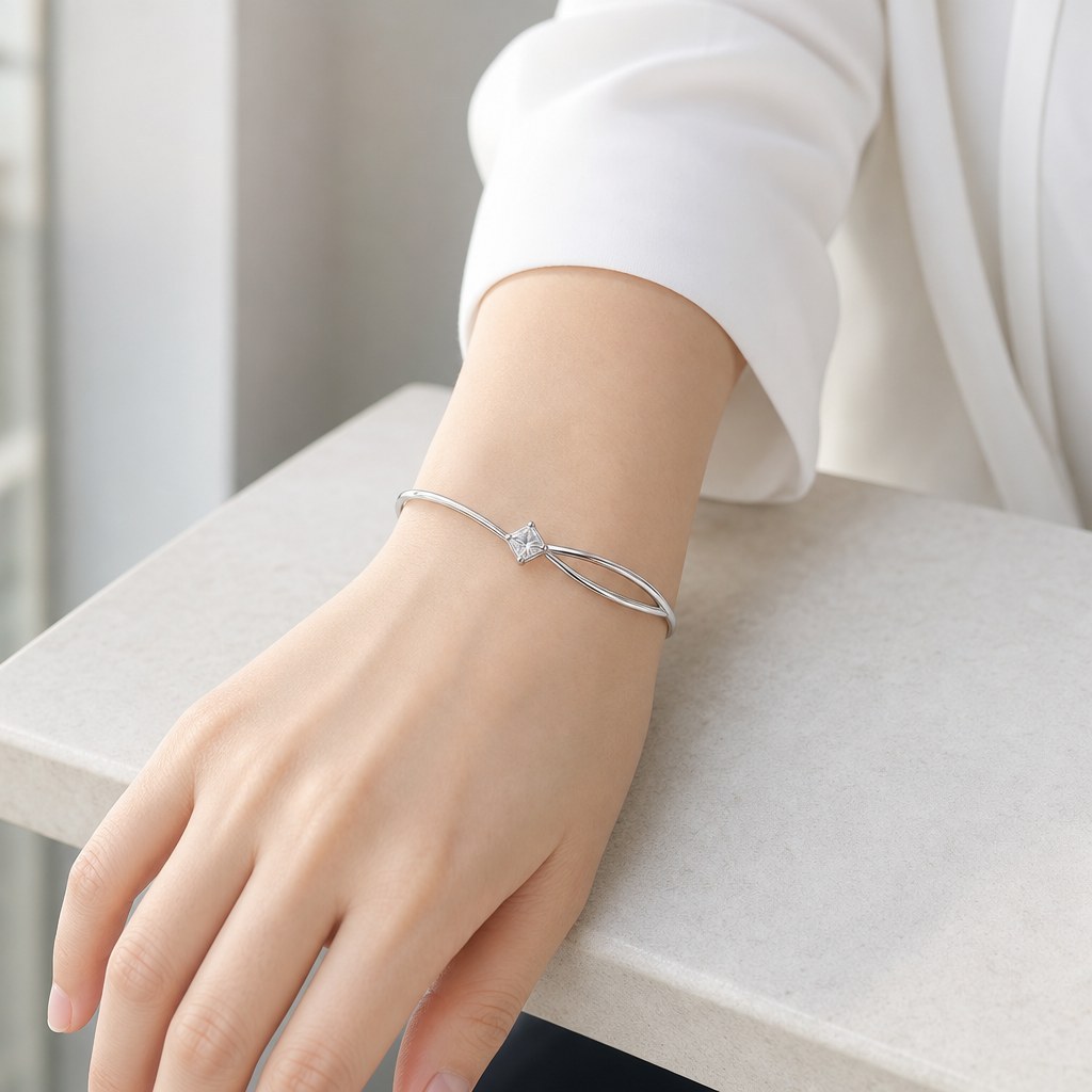 Twisted Double Strand Bangle worn on the wrist with a shirt cuff