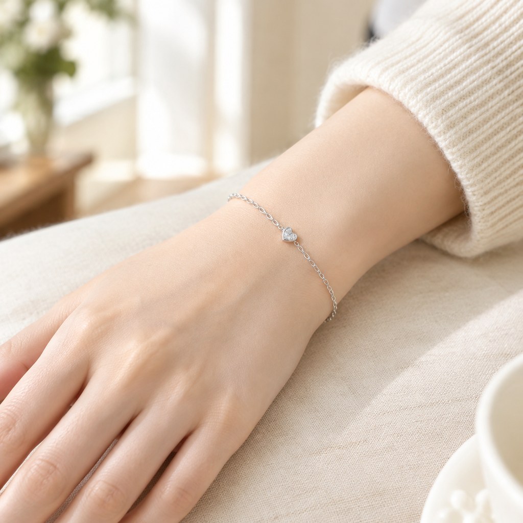 Heart charm bracelet worn on the wrist, the heart resting flat at the top
