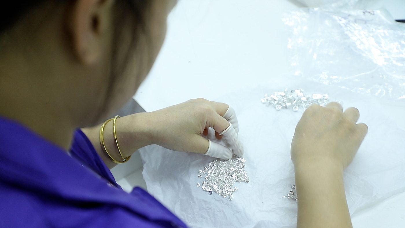 Close inspection of a sterling silver piece at Hengdian Silver