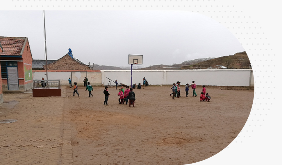 A bunch of kids playing on a dirt floor