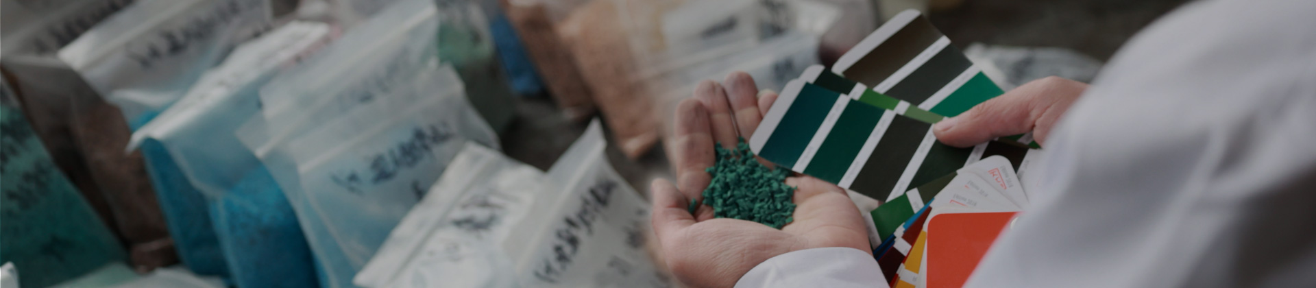 A man holding EPDM granules and colour cards